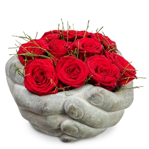 Stone hands with red roses
